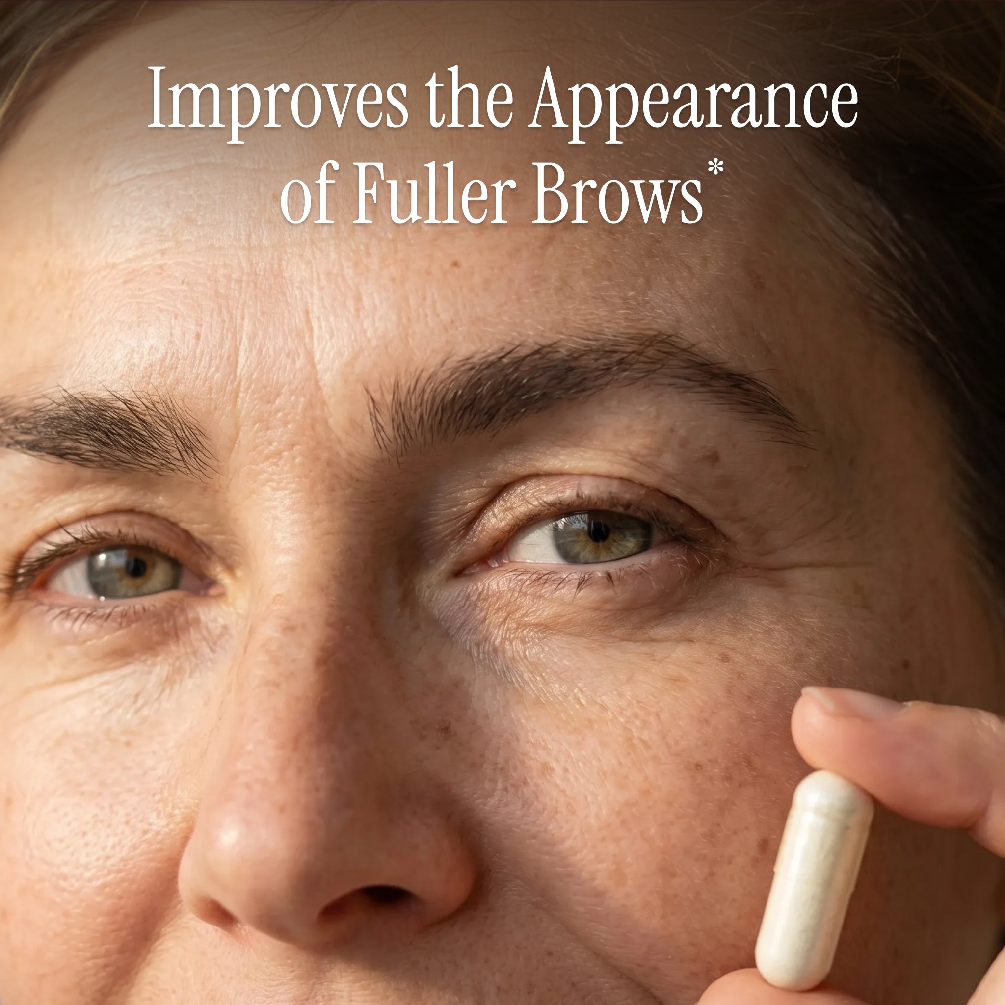 Close-up of a person holding a Purity Products My Biotin supplement capsule with text highlighting its benefits for improving brow appearance.