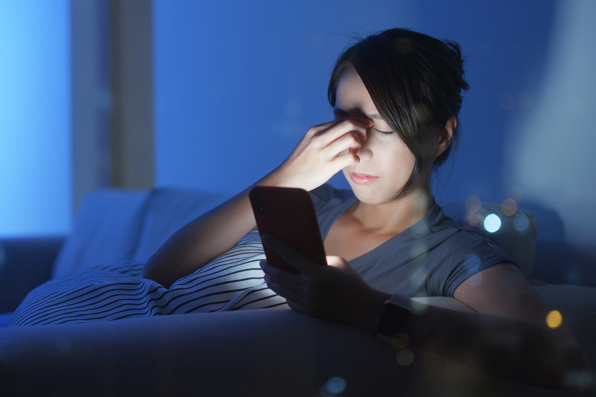 lady-rubbing-her-eyes-from-cellphone-usage