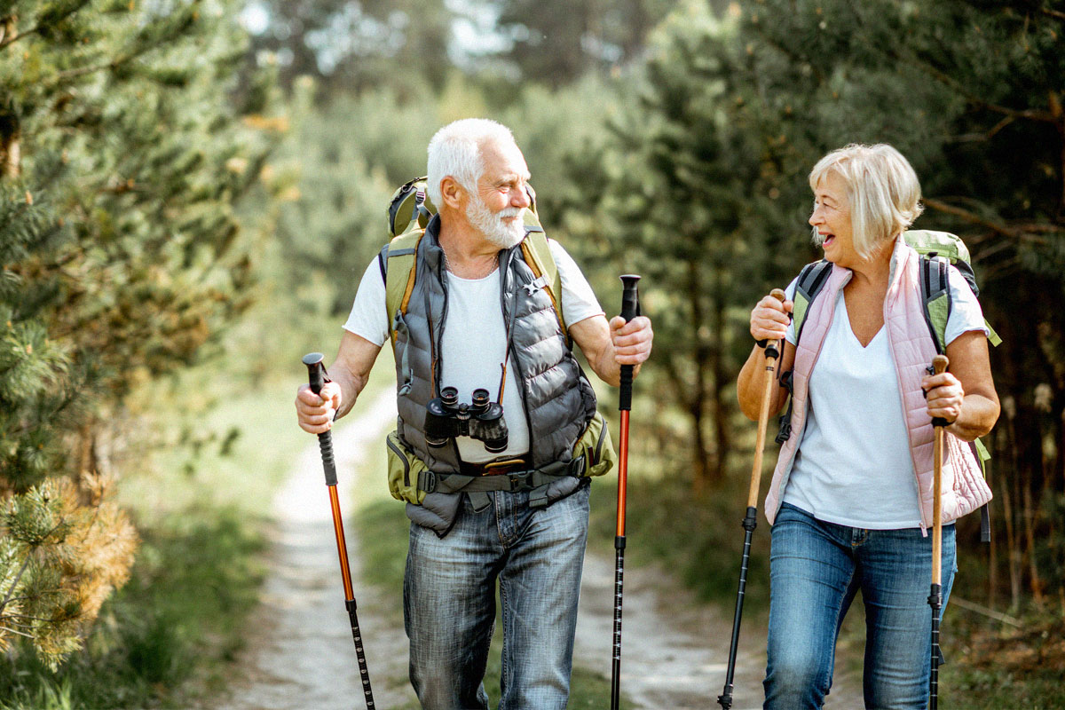 old-couple-hiking-in-woods